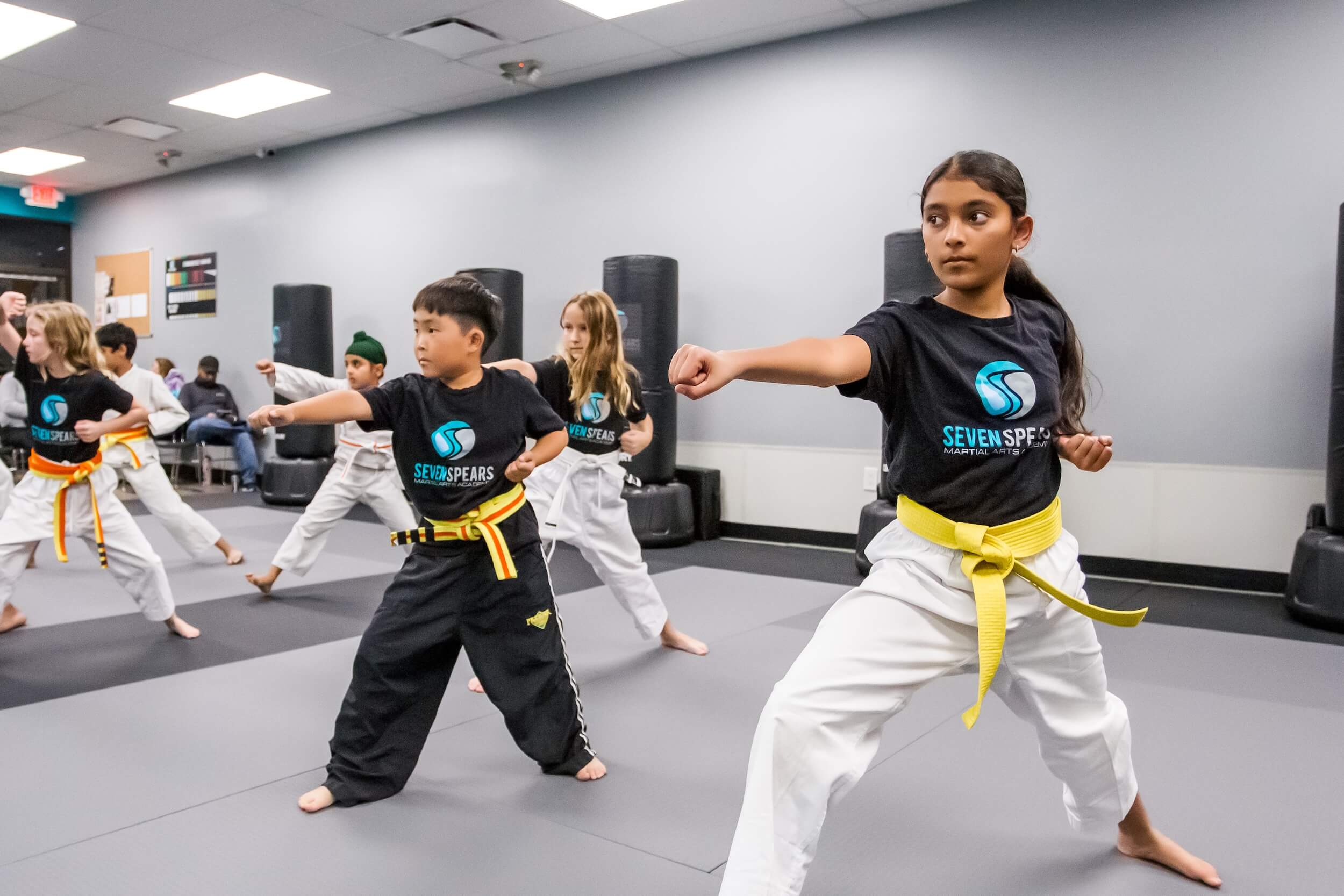 Seven Spears martial arts students practicing drills during class wearing gi uniform.